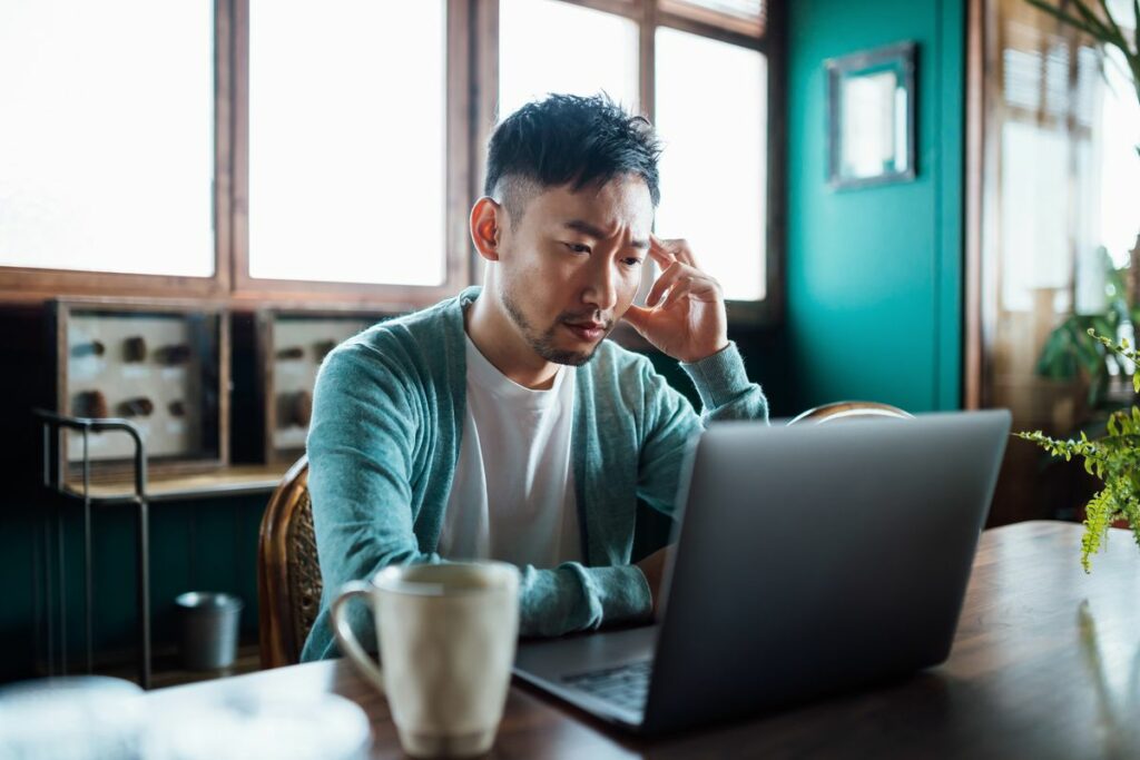 worried young asian man with his hand on head using royalty free image 1719168053